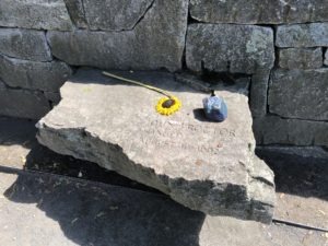 Memorial stone with flower and blue rock