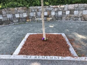 Tree with "We Remember" in stone