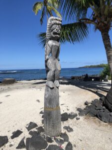 Wooden carving in front of beach