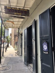 Covered sidewalk with doors and sign