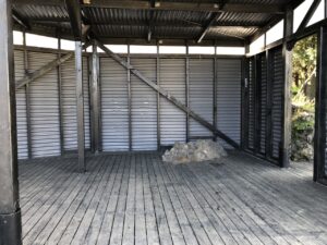 Wooden outdoor stage where floor was build around a stone