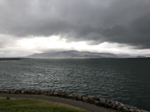 Mountain in distance with sea separating 